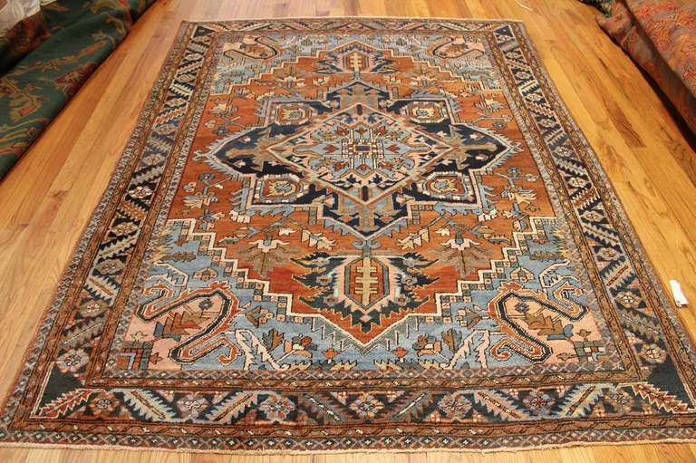 Produced in Northwest Persia in the district of Iranian-Azerbaijan, this Serapi carpet is an excellent example of the Heriz medallion and the locally-preferred color scheme, including coppery reds and the Classic Persian blue, which have acquired a