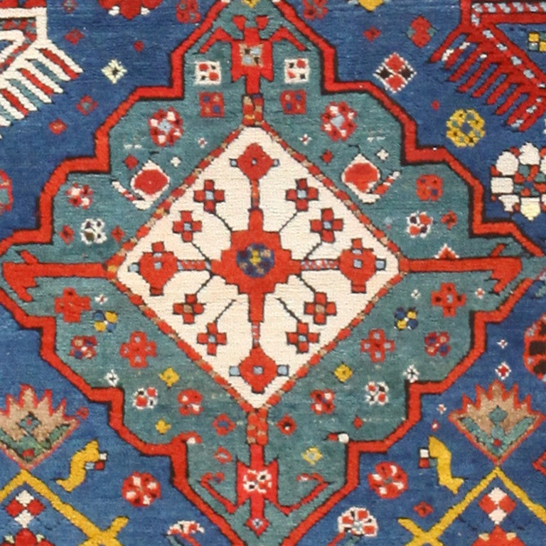 From the Caucasus region, on the coast of the Caspian Sea are known for their fine soft wool and medium pile. Typically Talish rugs feature a long narrow field of monochrome blue or teal and lack decoration save for a notched border of contrasting