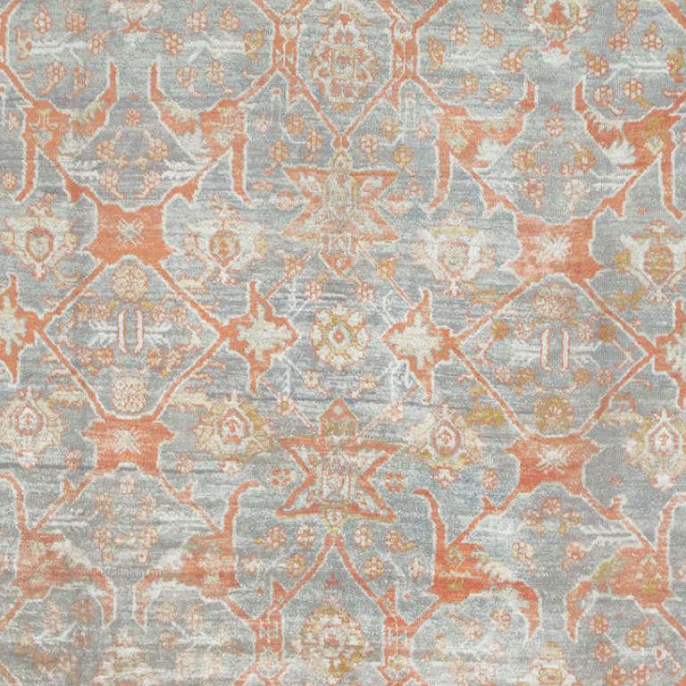 This sophisticated antique Angora Oushak carpet from Turkey depicts a beautifully rendered arabesque with angular motifs, elaborate palmettes and chic background motifs rendered in a stunning combination of oxidized terracotta red and grayish