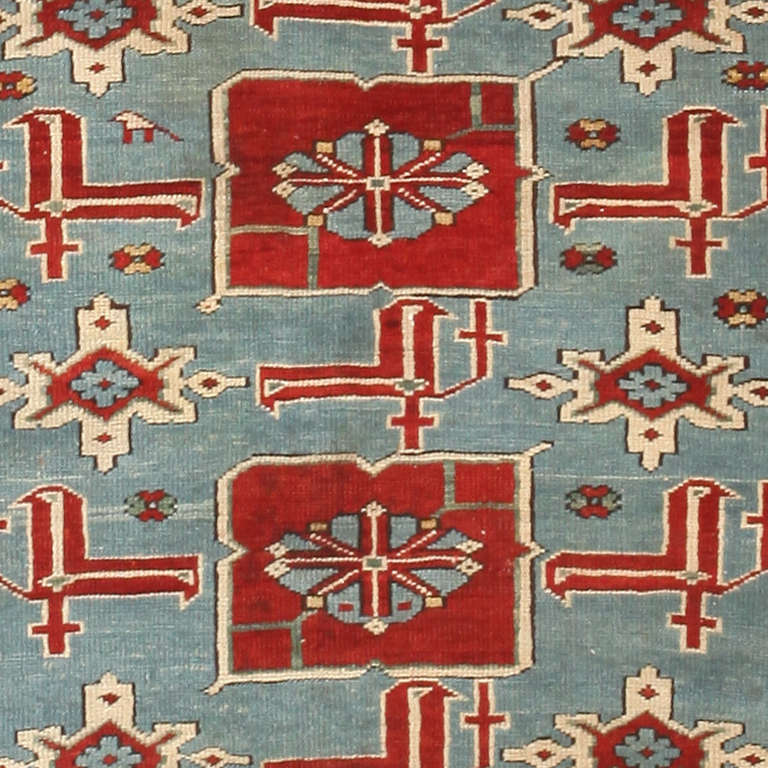 This handsome antique Caucasian rug is a phenomenal and truly archetypal example of regional rugs from the Azerbaijani village of Karakashly. This local variant of the Afshan pattern features crimson calyces with right-angle bifurcations and