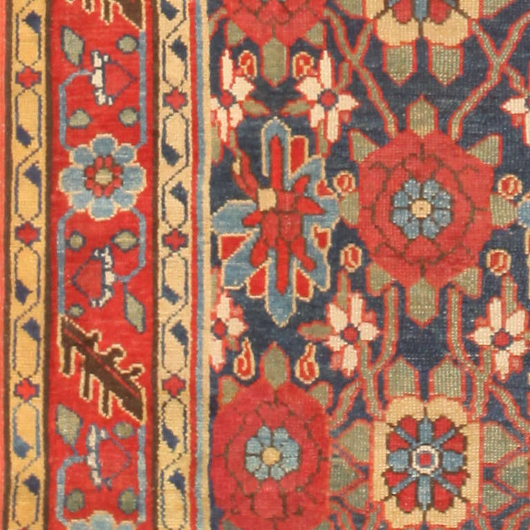 This distinctive antique Northwest Persian rug has a captivating botanical style that balances delicacy and strong graphic features. Teetering on the cusp of Persia's northern frontier, this magnificent village carpet brings influences from Persia's