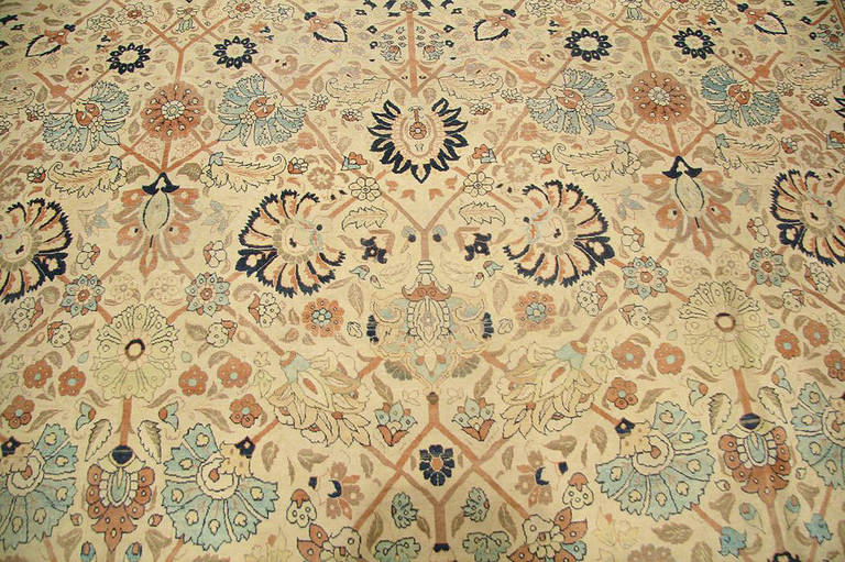 The Haji Jalili workshop is world renowned for producing the finest pieces in Persia. This antique Haji Jalili Tabriz rug features a grand sweeping palmette design. It recalls the great Persian court carpets of the 17th century Safavid dynasty. With