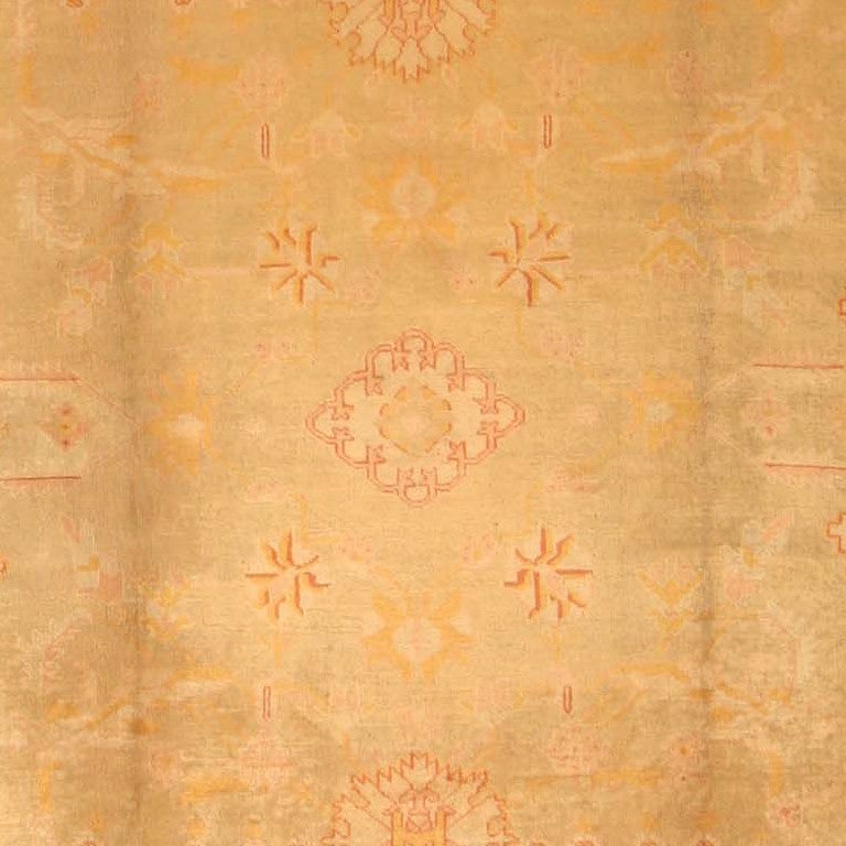 Antique Oushak carpet, Turkey, circa 1900. A delicate design of palmettes and leafy vines floats gracefully across the sage field of this lovely antique Oushak. Sparing use of maroon outlines provides a bit of accent for the soft,