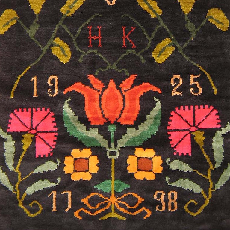 Antique Finnish Rya, dated 1925 This charming antique Finnish Rya has a classic Scandinavian folk art design of the eighteenth century rendered with absolute fidelity. Sprays of carnations, tulips, and poppies hover on a striking black ground,