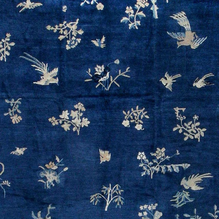 The restrained grandeur of classical Chinese rug weaving informs this masterful Ningshia carpet, made in an imperial manufactury in the waning years of the Manchu dynasty. Here amidst a relatively open blue field, floral sprays, flying birds and
