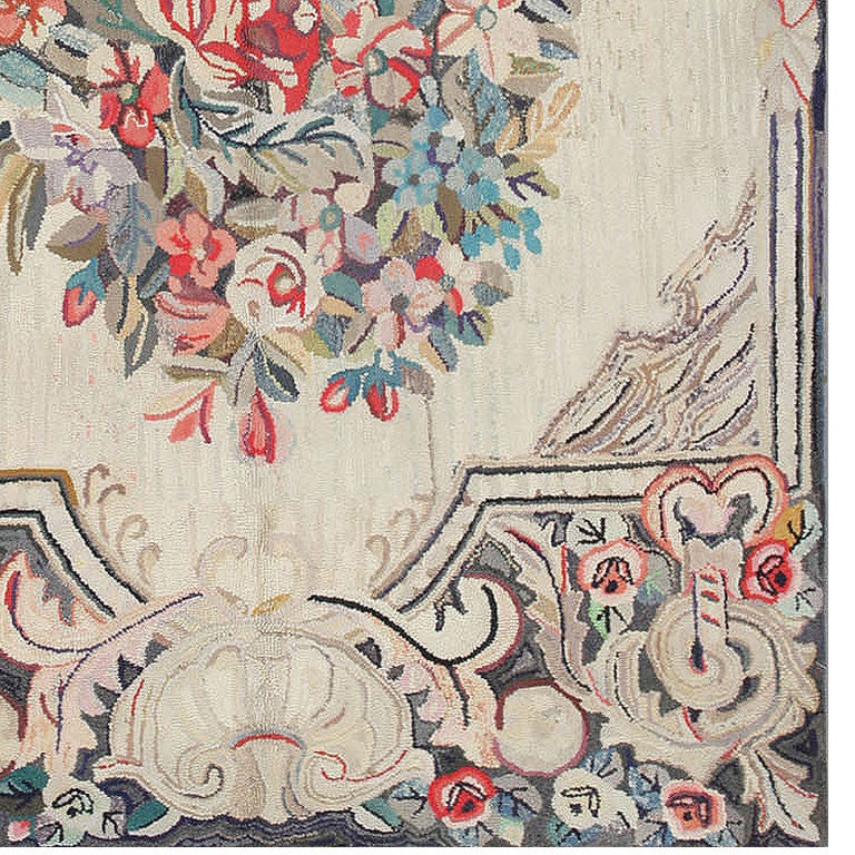 This large area rug displays a classic architectural frame with sculpted shells and acanthus leaf flourishes worked with the characteristically nubby carpet hooking stitch.

American Antique Hooked Rug, Woven in the United States of America, Circa: