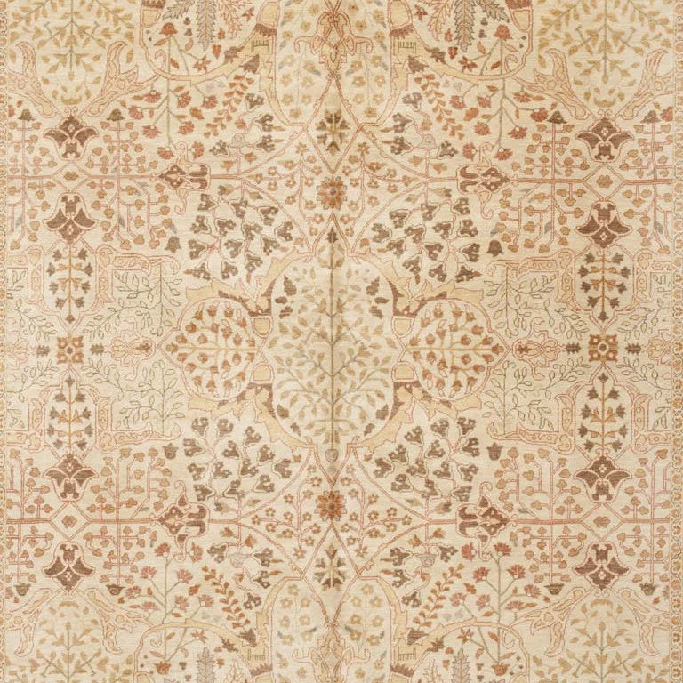 This lustrous rug woven in the Tabriz style is wonderfully decorative in all of its facets. Notice the subtle palette consisting of neutral yet warm ivories and browns with the suggestive hint of earthy red and green. Its all-over design makes it an