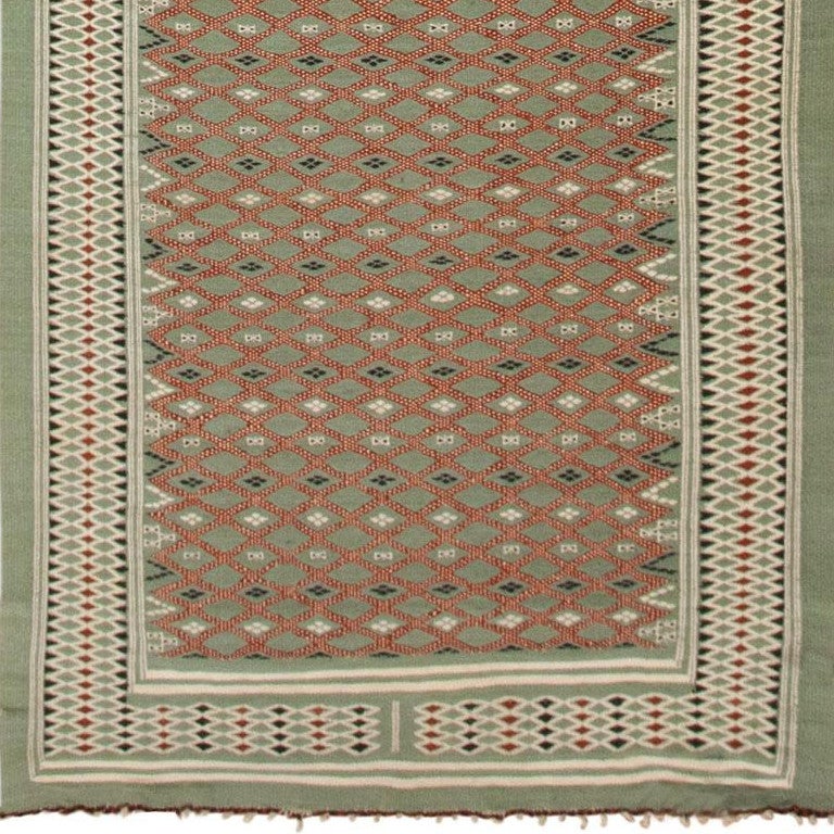 This exquisite and intricately detailed vintage Swedish rug created circa 1900 features a grand all-over latticework pattern embellished with small-scale motifs and secondary geometric elements. Bold auburn latticework bands bespeckled with