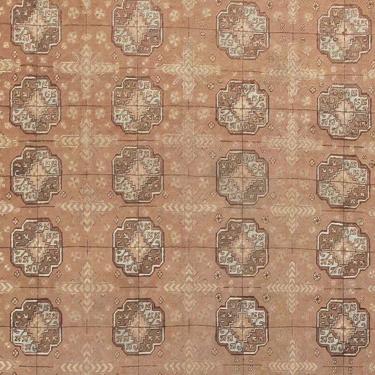 Antique Khotan Carpet, East Turkestan, circa 1900 Rows of lobed Turkoman medallions or 'guls' repeat in symmetry across the soft tan field of this lovely antique Khotan. The intervening space has cruciform 'minor guls' of Turkoman type as well.. The