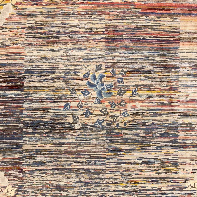 This striking Mongolian rug features a delicate floral medallion and spandrels set over a boldly variegated background incorporating vivid sunset hues. Woven in the 1920s, this Mongolian rug is a hometown version of classic Art Deco patterns that