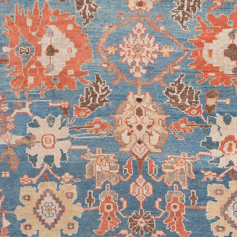 Inspired by historic Safavid designs, this exemplary antique Persian Ziegler Sultanabad rug re-imagined traditional Persian patterns with proportions, colors and motifs uniquely suited to Western tastes and interiors. The soft azure field features a