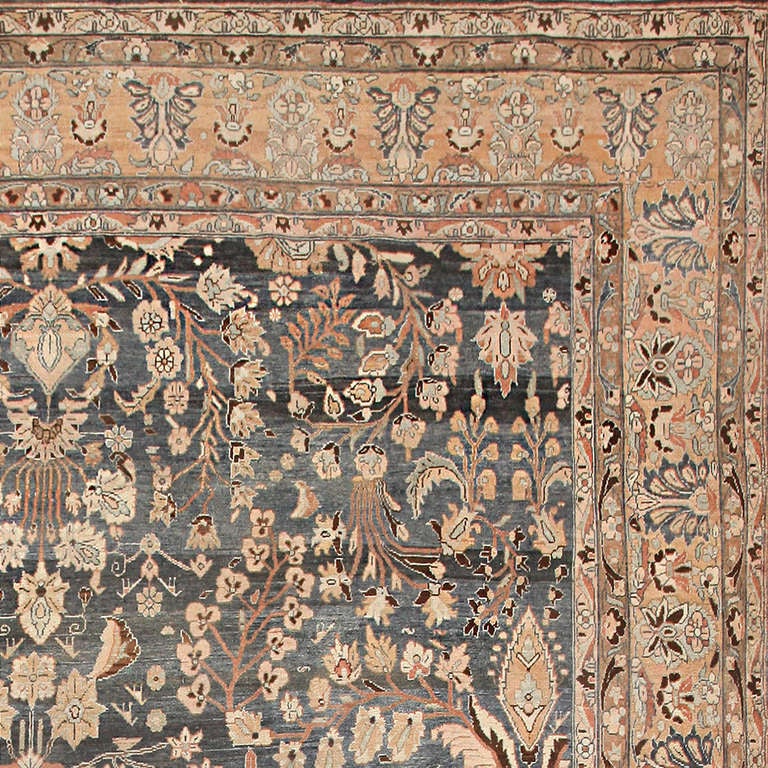 Handsome, earthy and beautifully appointed, this majestic antique Persian Malayer room-sized carpet has a patrician appearance and a powerful air of elegance. The exquisite umber ground displays a variety of nuanced undertones ranging from stormy
