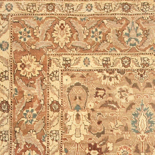 In the Tabriz tradition, this piece features a subtle, muted color scheme paired with superfluous arabesques inspired by the fluid Safavid style. Feathered palmettes, sinuous vinescrolls and curvilinear floral sprays with accents in burnt sienna,