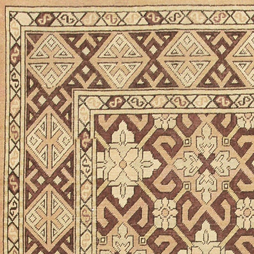 Antique Khotan, East Turkestan, Early 20th Century - This stunning antique carpet from Khotan is decorated with an elegant repeating pattern featuring fretwork-decorated polygons that merge with a secondary latticework grid. Fantastic borders
