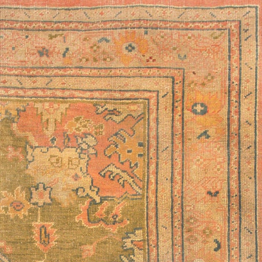 This charming Turkish carpet features a prominent ivory medallion decorated with serrated yildiz symbols representing happiness and heaven along with Harshang variants that include angular limbs woven in a combination of apricot pink, pale blue and