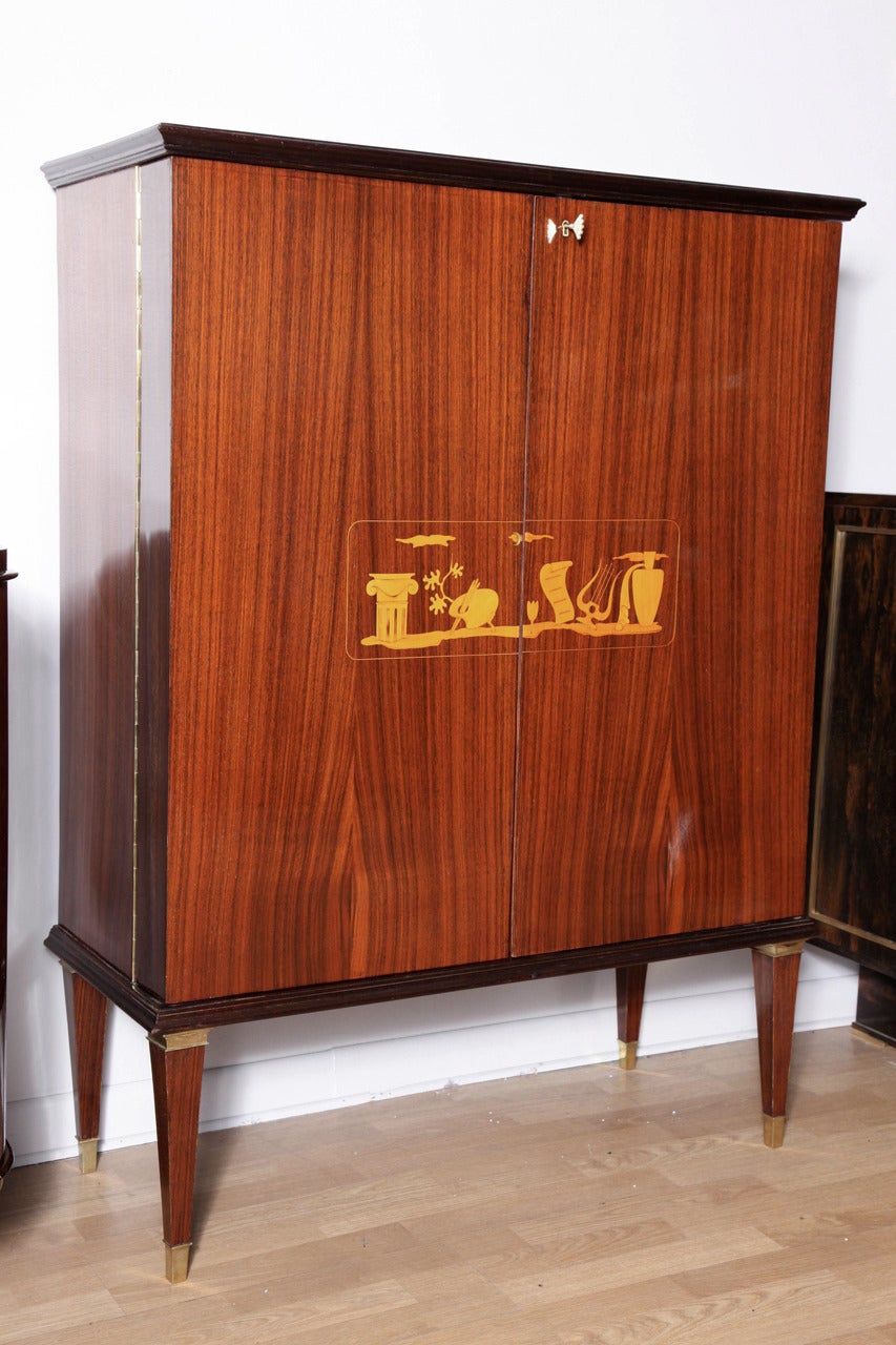 A superb Art Deco bar/cabinet by Paolo Buffa. Beautiful intarsia detailed palissandre cabinet. The interior is also finished to a very high standard including drawers, mirrored bar, and removable serving trays.