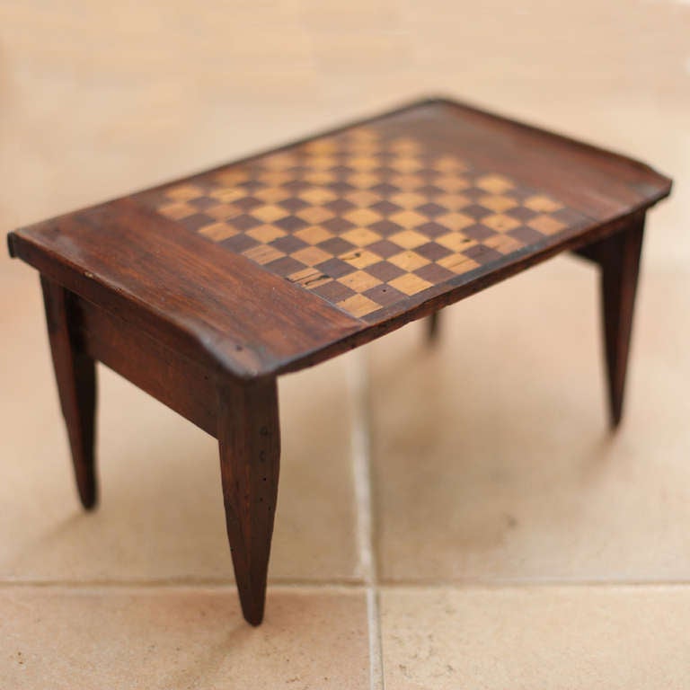 Miniature chess / checker table in French walnut with inlaid contrasting checkerboard pattern on top. Made in 1890