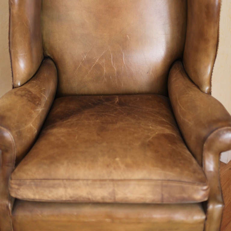 1940's English leather wing back chair with wonderful patina. Nail head trim and mahogany legs. The kind of character that only comes with time.