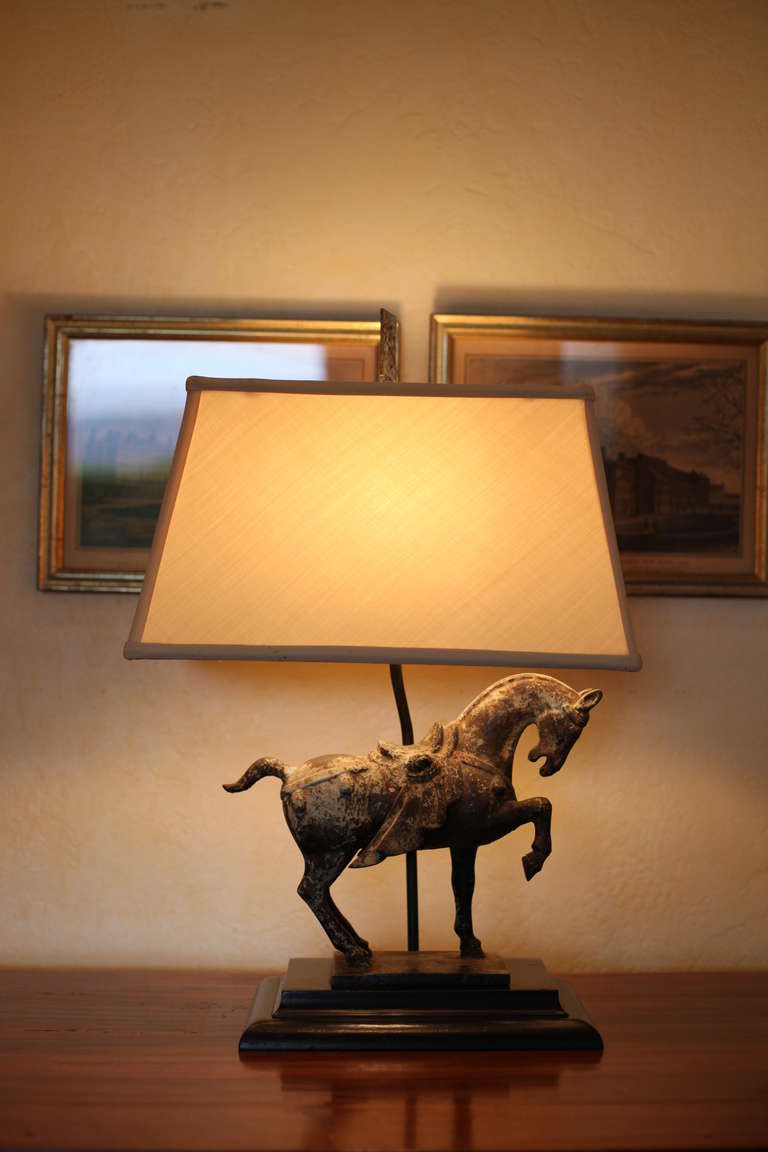 Beautiful lamp with horse sculpture and contemporary lampshade.