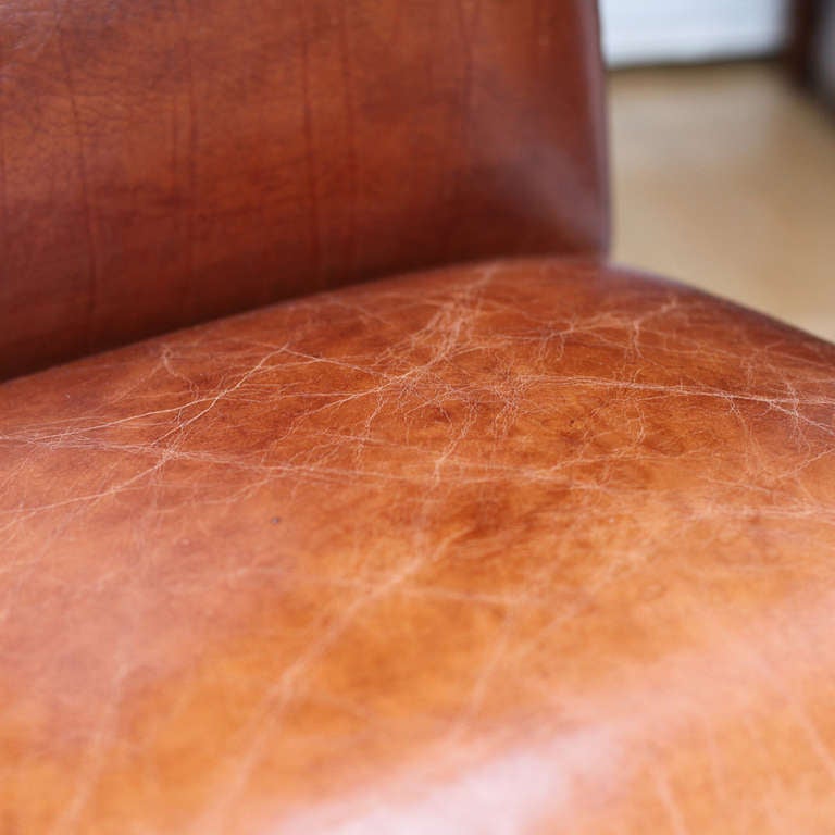 19th century French walnut high back chair. Turned and dowelled legs with deep antique patina. Reupholstered with a dark tan leather and finished with nailhead trim.