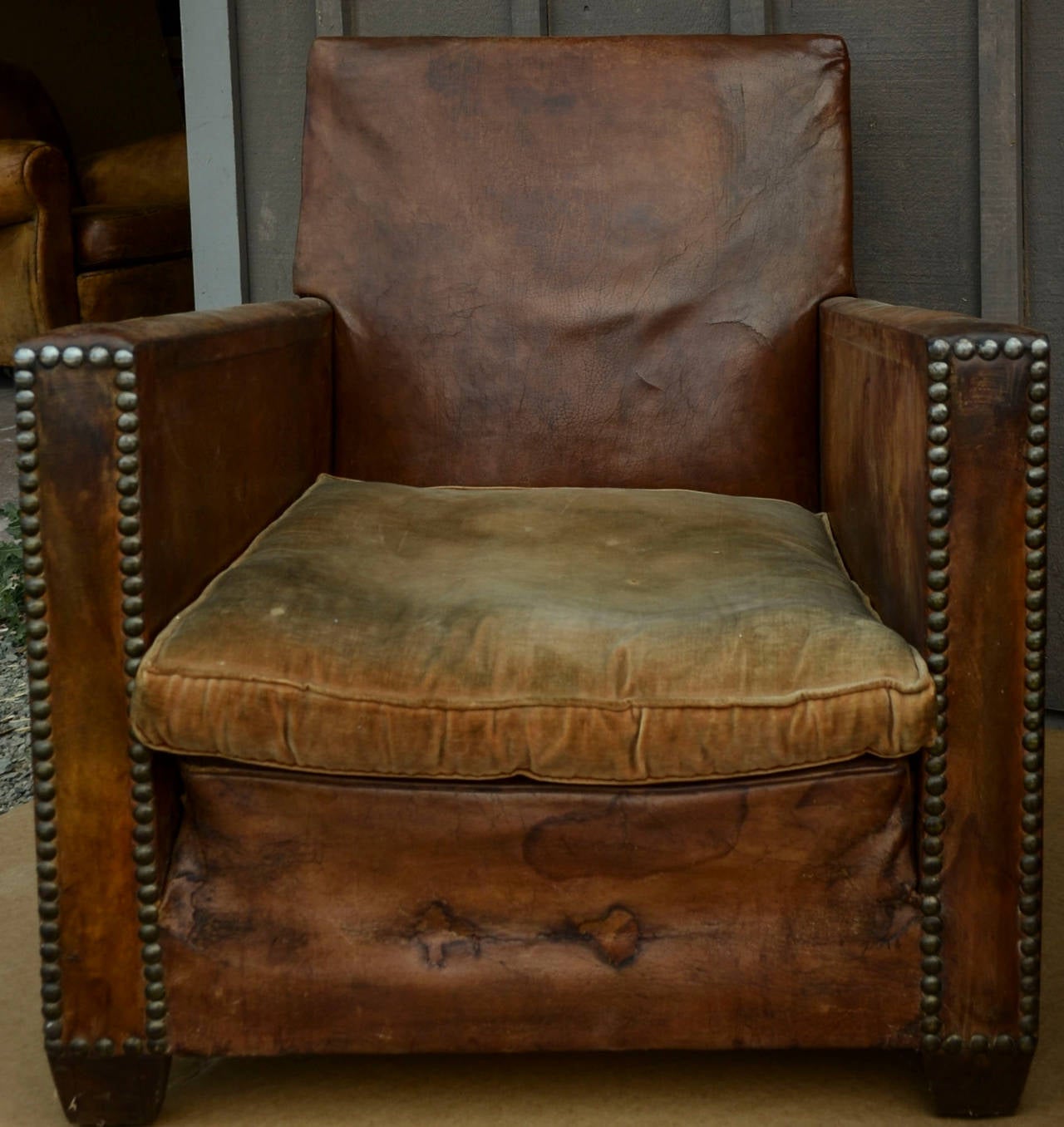 A pair of lovely vintage distressed leather club chairs. Approx 20th Century. Wear consistent with age and use. Price for set of chairs.