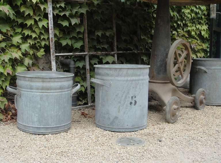 French metal grain tins from the early 1900s. Individually numbered and of variable height and width.

Please inquire regarding availability. 

