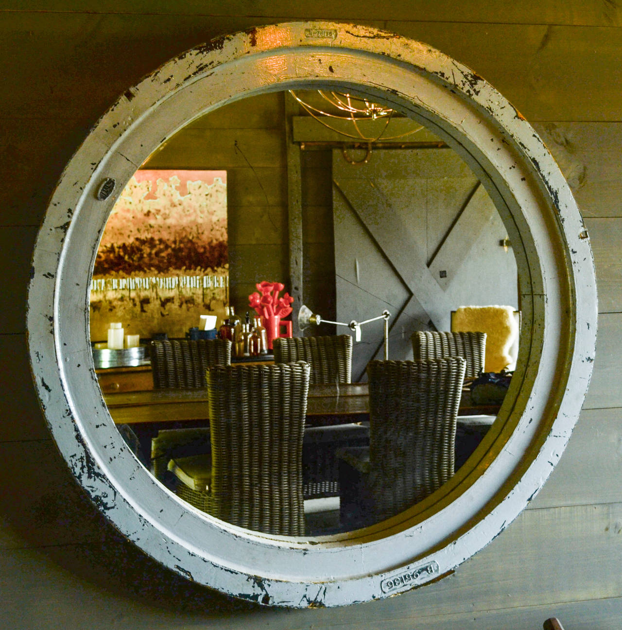 Large circular mirror with beautifully textured industrial wood frame from France. Perhaps a re-purposed industrial mold from a foundry. Painted grey, with areas of weathering as illustrated in the photographs, plus a few scratches behind the glass.