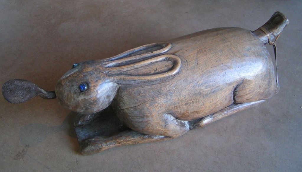 Carved rabbit wood coconut scraper with glass eyes
