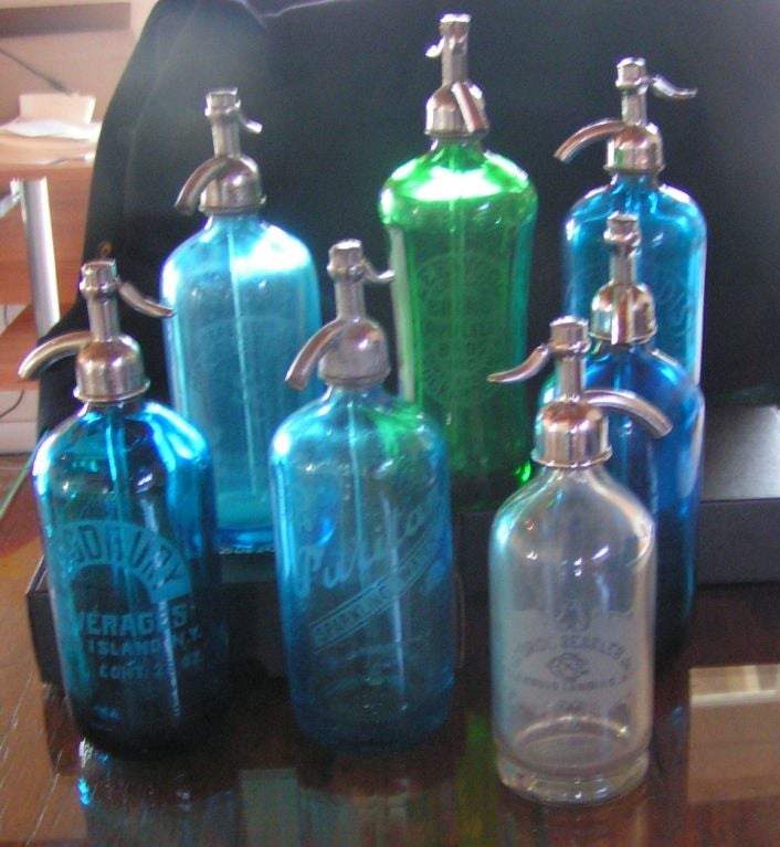Wonderful assortment of vintage American seltzer soda bottles, sold individually.  Several of them are in shades of aqua blue, one is green with faceted sides and one is clear.  Attributions include 