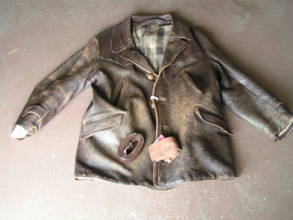Handsome leather barn jacket from Belgium, circa 1940's.  Amazing condition for its age.  Has wool lining and two belts; one cloth and one leather.  Beautiful patina on leather, soft wear on the sleeves.  Will fit 44 to 46 men's approx 6'2