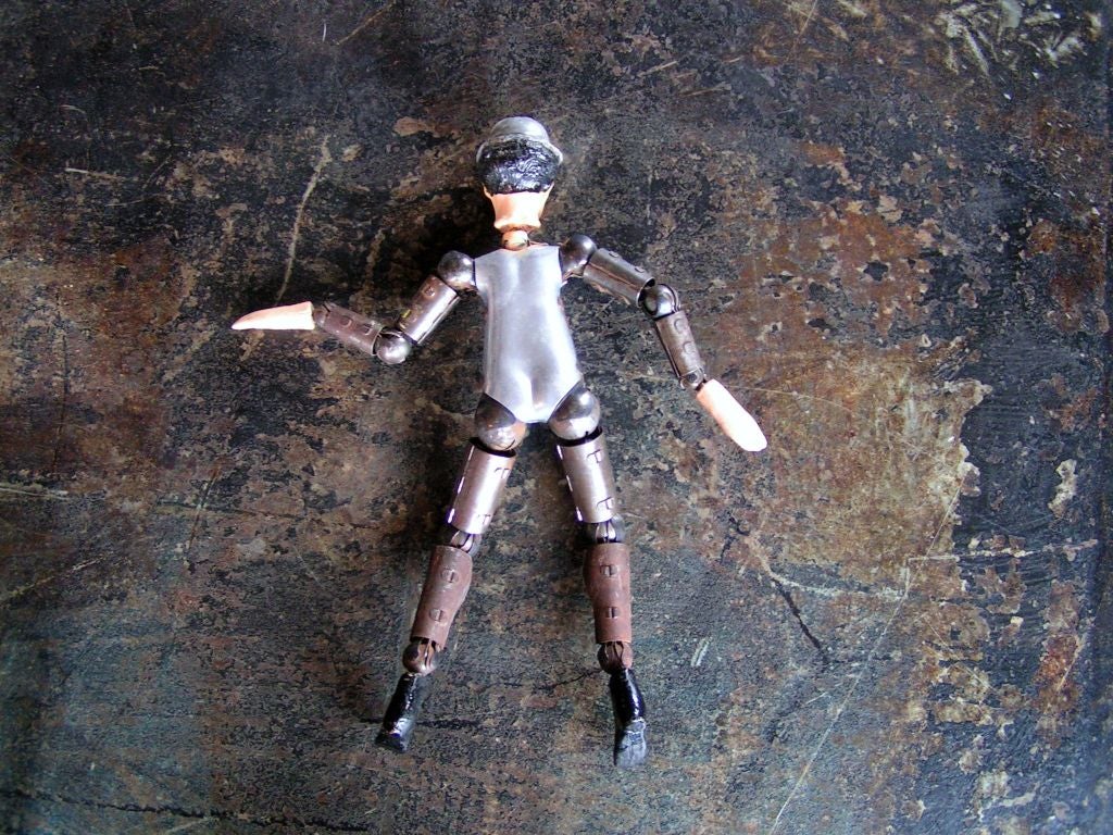 Aluminum Bucherer Charlie Chaplin doll with articulating joints made by Swiss watch company. Unusual antique toy, wonderful patina.