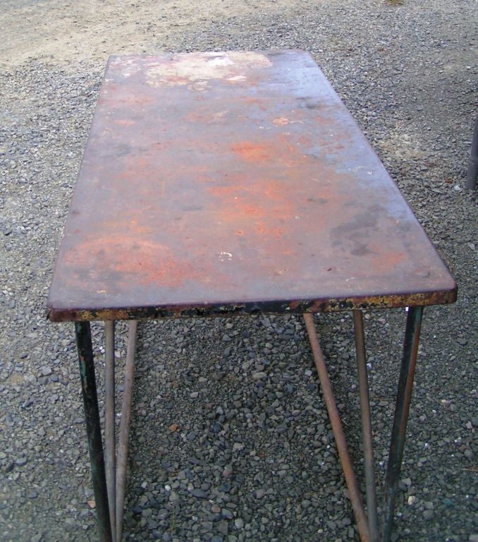 Metal console table with beautiful rusty patination, hints of paint.