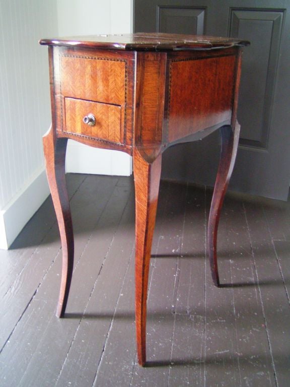 Late 19th century marquetry side table with fine herringbone motif. One-drawer with a double-sided hinged top that opens to a storage compartment.

  