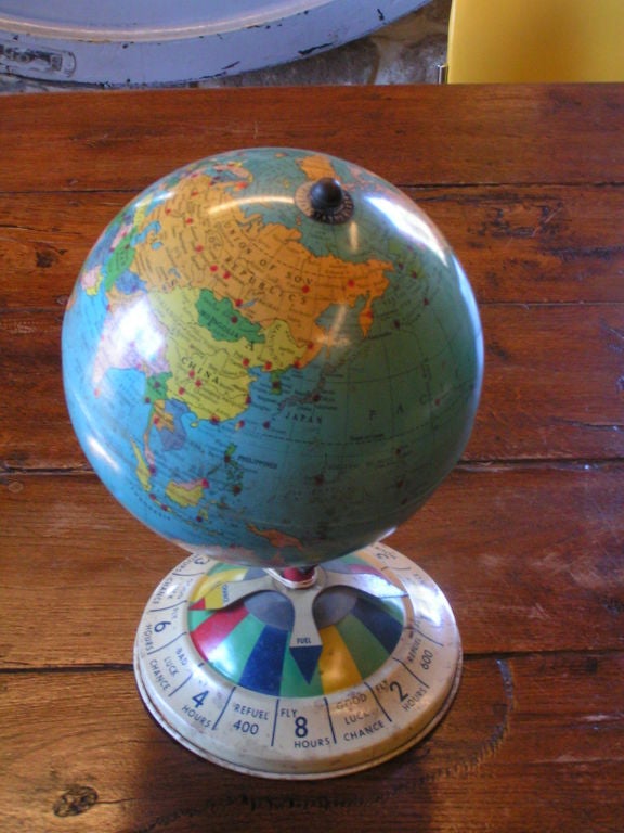 Wonderful globe with bright colors, red dots marking coordinates, spinning game arrows on the stem and game consequences on the base.  This is a very fun, unique globe that was part of a game.  There are no other associated parts to the original set.