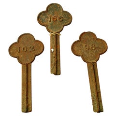 Set of Four Cast Iron Quatrefoil Numbered Grave Markers, 19th Century
