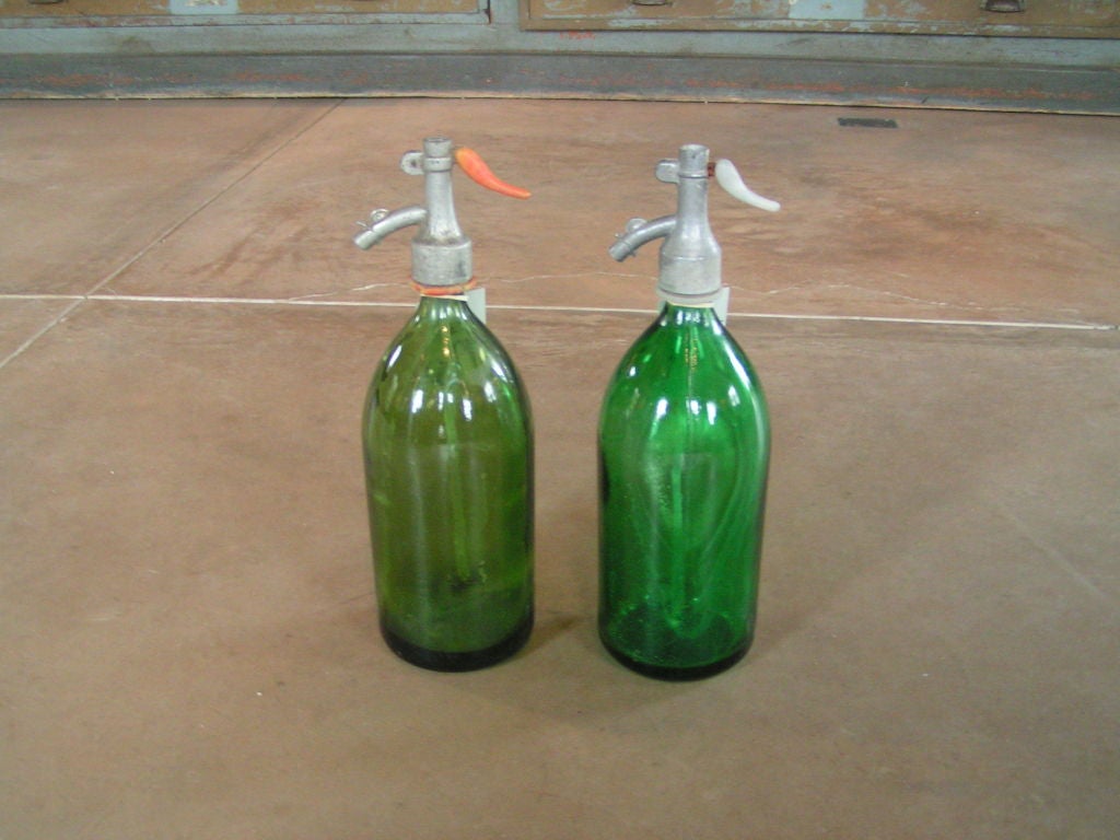 Heavy glass vintage soda bottles.  Tops are metal, some have plastic as well.  Glass is cast but very unique in that thickness of it is not uniform everywhere.  Very authentic hand cast look to them.  Primarily green bottles.  Sold seperately for