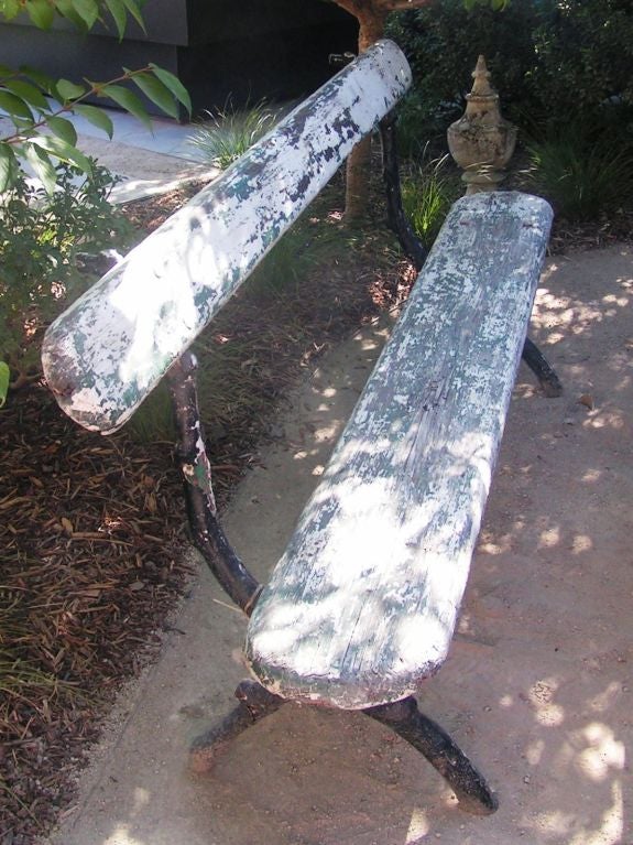 Very nice white (painted over green) garden bench.  The legs were cast to look like branches, which adds a natural feeling, rustic touch.  There are layers of paint added to the legs, which are now predominantly black.

