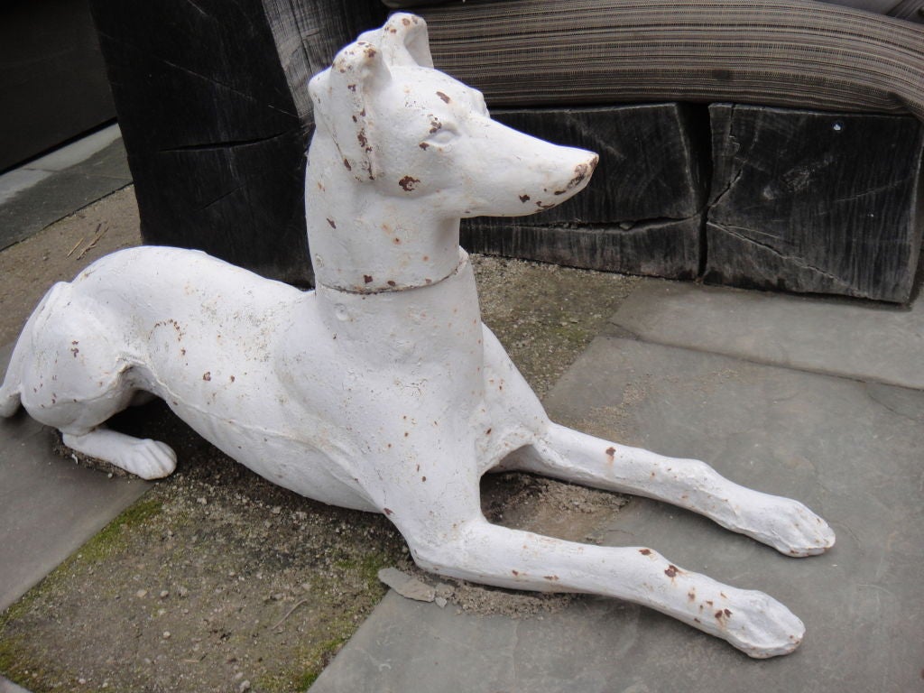 Set of two cast iron whippets painted white.

Please see images for detail of patina. 

