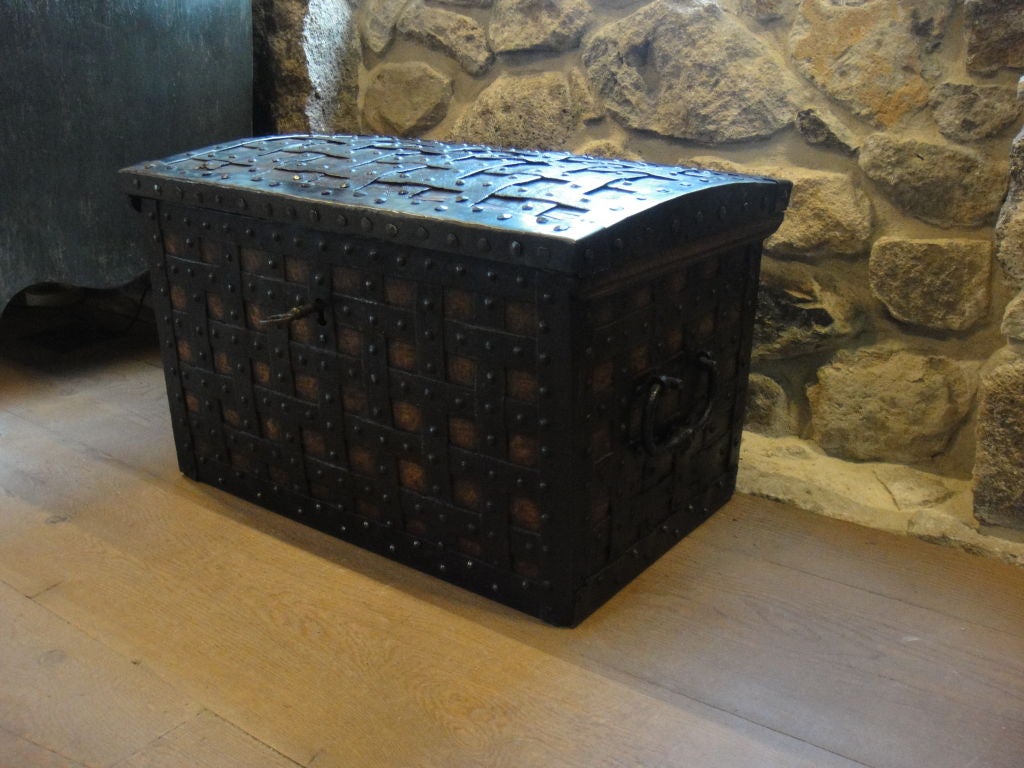 This is an exceptional coffer or strongbox.  It is very heavy empty, built to handle a lot of gold coins!  Iron bands are woven and nailed to the wood and cover all the edges.  The lock mechanism is incredibly heavy duty and works smoothly.  The