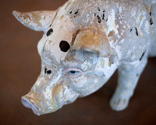 Antique butcher shop promotional plaster pig. Hand painted white with black spots.