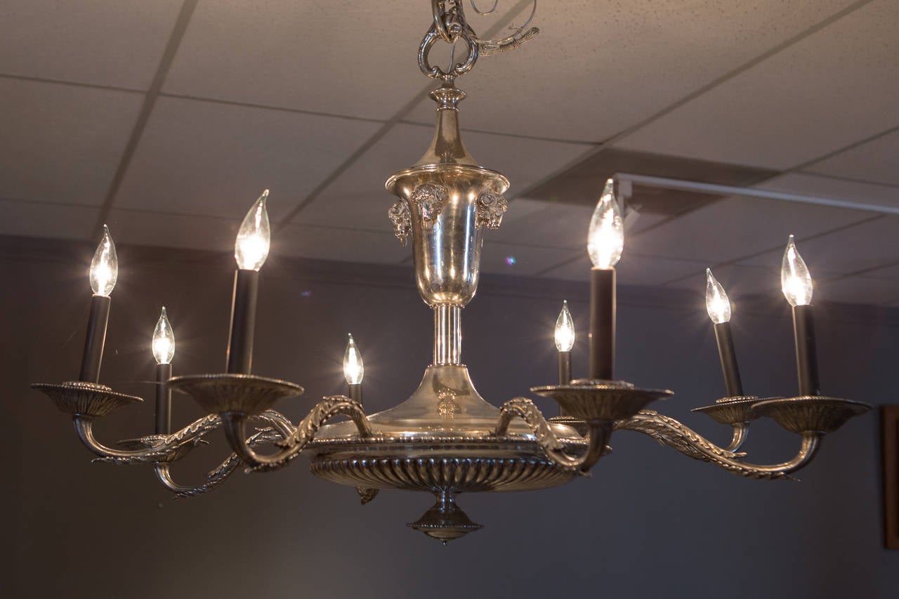 French silver plate neoclassical chandelier with applied ram's heads supporting a lower fluted bowl with eight arms. Similar style canopy included (not pictured).