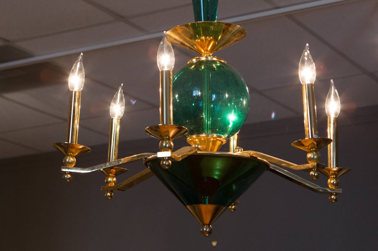 Mid-Century chandelier with flat, graphic brass arms, globe center, and glass bottom cup. Newly rewired.
