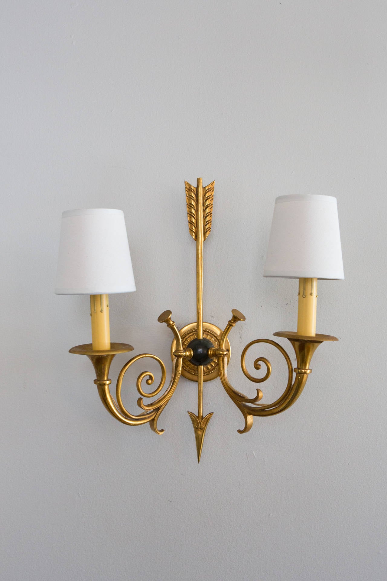 Pair of 1940's Empire style, 2 arm wall sconces in gold brass. In the manner of Maison Charles. Rewired.
