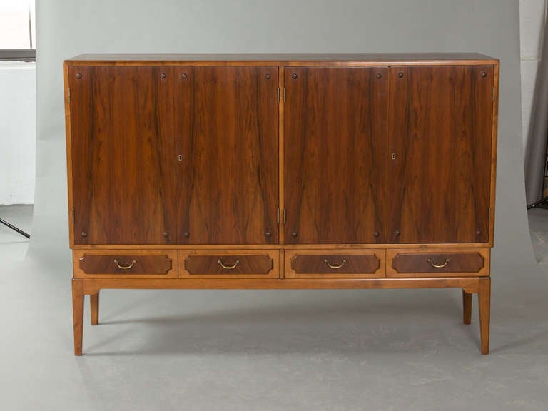Stylish, Mid-Century Danish cabinet with pair of double door compartments with interior shelves and four lower drawers with original hardware. Fully restored.