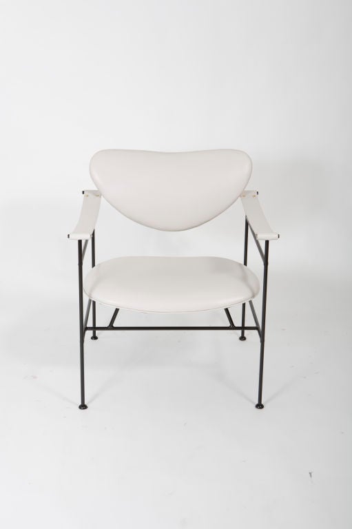 Architectural pair of Mid-Century black iron armchairs newly upholstered in off white saddle leather.<br />
Seat height - 16