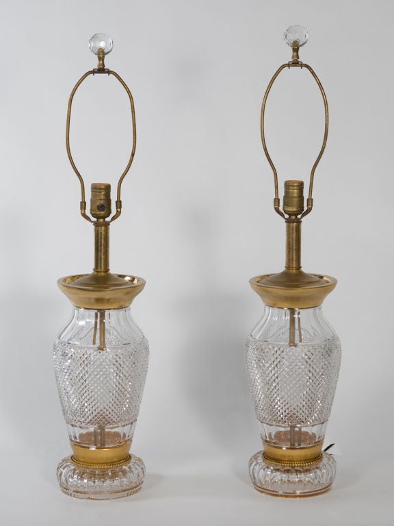 Pair of cut crystal lamps with gilt accents attributed to Waterford. Can be rewired for additional charge.
Shade not included.