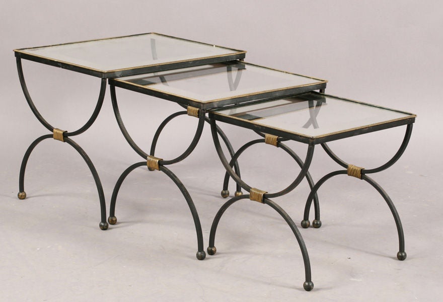 Set of three French wrought iron nesting tables with mirror framed glass tops and gilt accents. Some age appropriate oxidation to mirror and metal.<br />
<br />
Middle table has minor edge chip to mirror top. Can be replaced at additional charge.