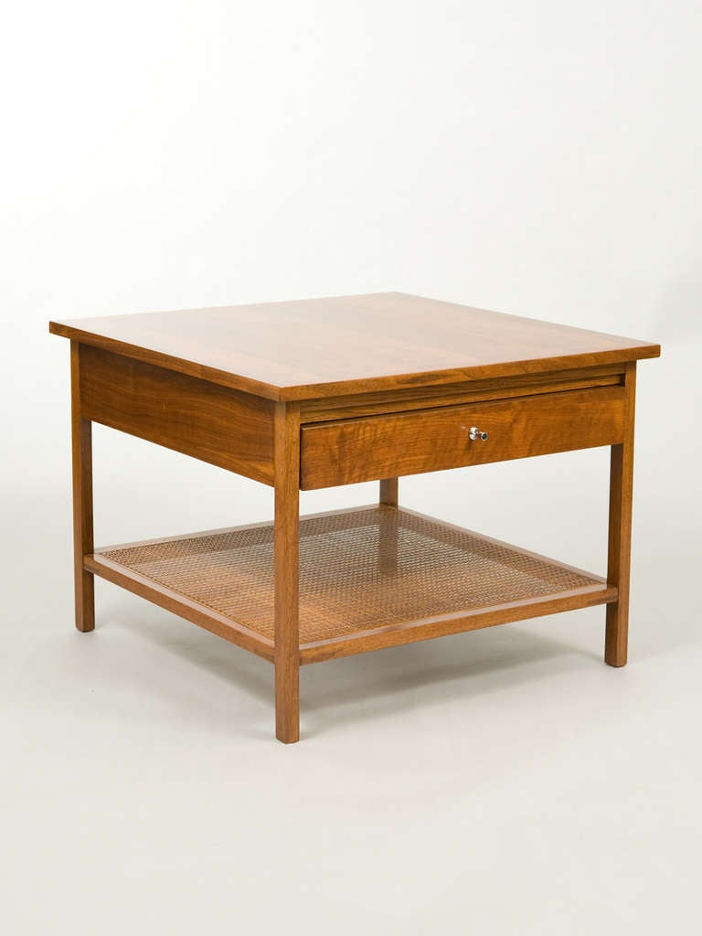 Architectural Mid-Century modern teak end table by Lane with one drawer and cane lower shelf.