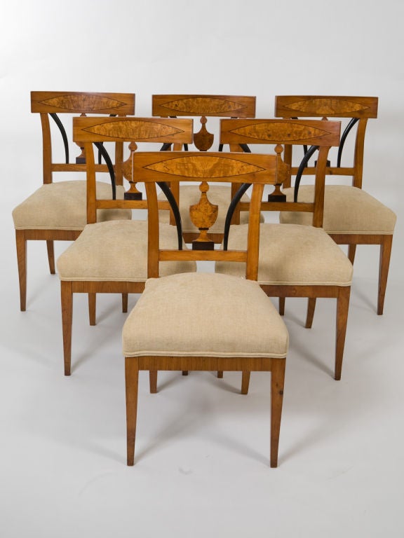 Elegant set of six Neoclassical style Biedermeier burlwood and fruitwood side chairs with urn motif and ebonized wood accents.<br />
Seat height - 18.5