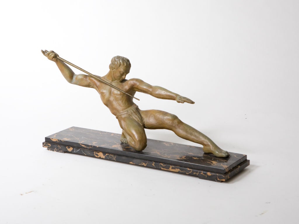 Art Deco figural bronze of a javelin thrower with patina mounted on a black marble base.